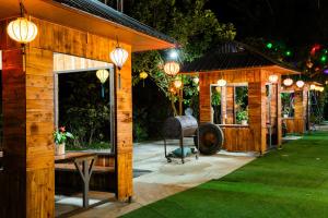 a wooden shed with a table in a yard at night at Hang Mua Eco Park in Ninh Binh
