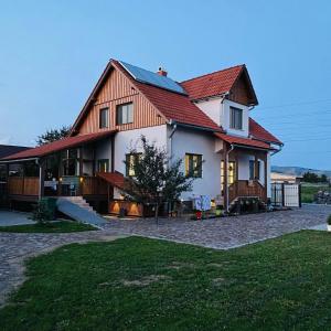 a large white house with a red roof at Mese Szálló in Lăzarea