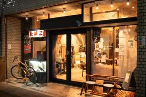 a store front with a bike parked outside of it at KARASUYA GuestHouse in Takasaki