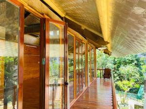 an open porch of a house with glass doors at HomeStay Pickle ball in Ðồng Vo