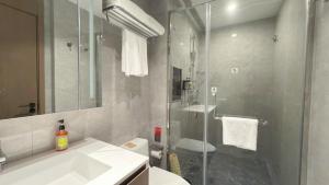 a bathroom with a shower and a sink and a toilet at Citadines Luyang Hefei in Hefei +29 photos