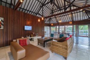 a living room with a couch and a table at Miko Villas Ubud in Ubud