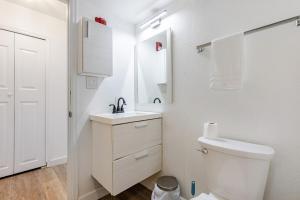 a white bathroom with a sink and a toilet at The Chautard Suite in Pueblo +47 photos