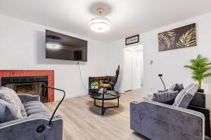 a living room with two couches and a fireplace at The Chautard Suite in Pueblo