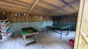 a room with a pool table and a ping pong table at Glamping at Honnington Farm in Royal Tunbridge Wells