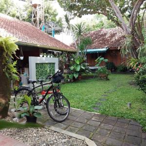 a bike parked in front of a house at rumah566 in Yogyakarta