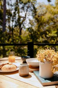 a wooden table with plates of food on it at Norfolk House in Dunsborough