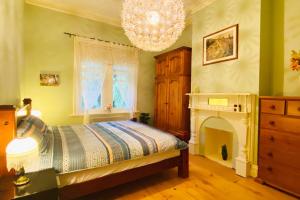 a bedroom with a bed and a chandelier at Hidden Getaway in the City in Mount Gambier