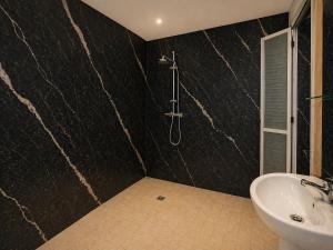 a bathroom with a sink and a shower at Hotel Albatros Wallis in Alele +7 photos