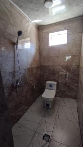 a bathroom with a toilet and a shower at Zaur Guest hause in Xınalıq +127 photos