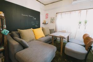a living room with a couch and a table at Kominka Hakone Entire Traditional House in Hakone