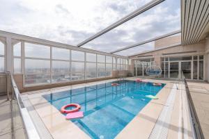 an indoor pool with a view of a building at Weekend Hotel Sari in Jeddah