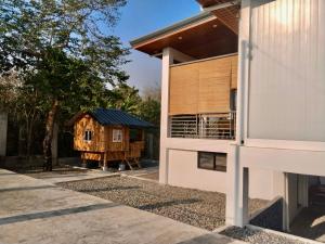 a house with a shed next to a building at U Cube Staycation in Manaoag