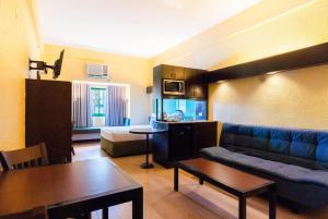 a living room with a couch and a table at Microtel by Wyndham Cabanatuan in Cabanatuan