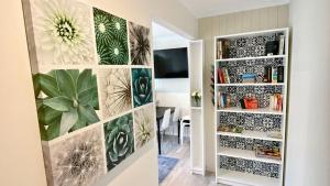 a living room with plants on the wall at Studio 66 Busselton in Busselton +4 photos