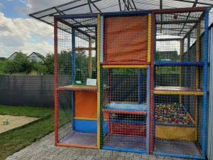 a cage filled with lots of different types of animals at Repos Domki Łeba in Łeba
