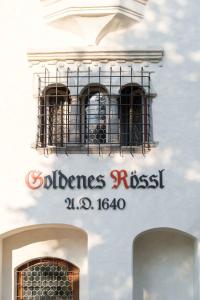 a building with a window with a sign on it at Hotel Goldenes Roessl-adults only in Bressanone