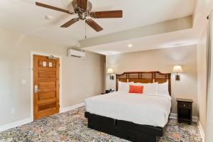a bedroom with a bed and a ceiling fan at The Port Inn - Port St Joe, an Ascend Collection Hotel in Port Saint Joe +66 photos