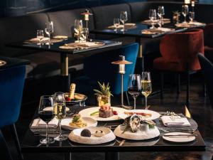 a table with plates of food and glasses of wine at DoubleTree By Hilton Seoul Pangyo in Seongnam