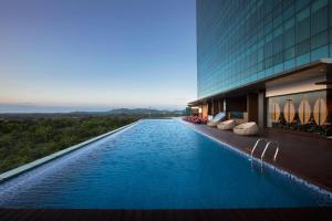 a swimming pool in front of a building at Wyndham Panbil Batam in Batam Center