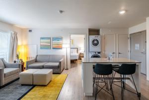 a kitchen and living room with a couch and a table at WaterWalk Extended Stay by Wyndham Wichita in Wichita