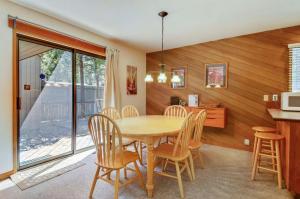 a kitchen and dining room with a table and chairs at Meadow House 21 in Sunriver