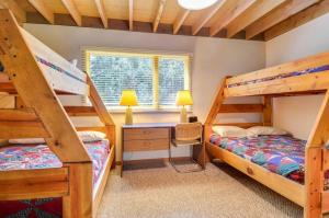 a bedroom with two bunk beds and a desk at Meadow House 21 in Sunriver