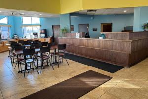 a lobby with a bar with chairs and a counter at Days Inn by Wyndham Sault Ste Marie MI in Sault Ste. Marie