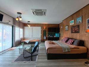 a bedroom with a bed and a chair in it at Baan Sahai Tone บ้านสหายโทน in Ko Larn