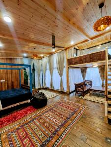 a living room with a bed and a rug at Cloudwalks Homestay in Kodaikānāl