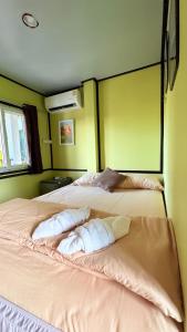 a bedroom with two beds with pillows on them at Kohlibong forest house in Trang +60 photos