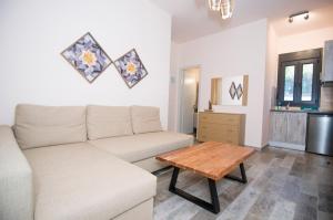 a living room with a couch and a coffee table at Villa Saravari in Áyios Aléxandros