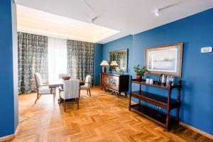 a dining room with blue walls and a table and chairs at Warwick Palm Beach Hotel in Beirut
