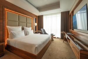a hotel room with a bed and a flat screen tv at Weekend Hotel Sari in Jeddah +94 photos