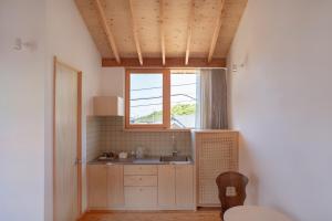 a kitchen with a sink and a window at ホテル聚 - Hotel SHU in Tonosho