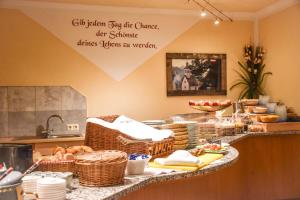 a kitchen with a counter with baskets of food at Berghotel Almrausch in Berwang