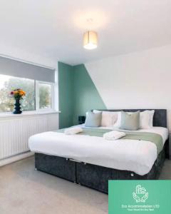 a bedroom with a large bed with a window at Modern 3BR Durham Stay for Work Trips in Brandon