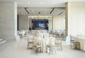 a banquet hall with white tables and chairs at Hilton Panama in Panama City