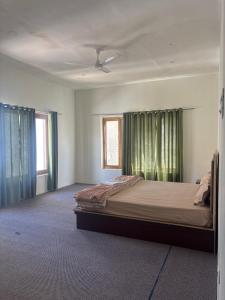 a bedroom with a bed and two windows at Dod gu Yongs Khil in Karu