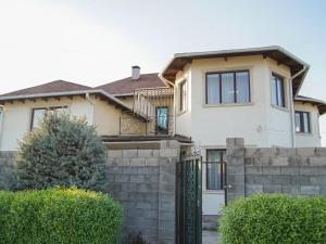 a house with a fence in front of it at Dolon Hostel in Bishkek