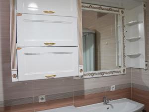 a bathroom with a sink and a mirror at Dolon Hostel in Bishkek +22 photos