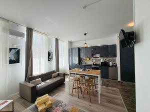 a living room with a couch and a table at Sunny Studio Apartment in Iaşi