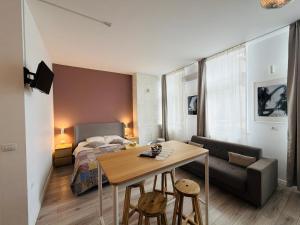 a small apartment with a table and a bed at Sunny Studio Apartment in Iaşi