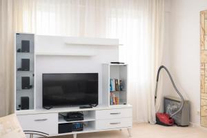 a white entertainment center with a flat screen tv at Villa Elma in Kuşadası