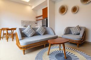 a living room with a couch and a table at Pondok Naya Ubud in Ubud