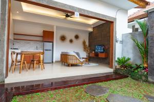 a kitchen and dining area of a house with a patio at Pondok Naya Ubud in Ubud