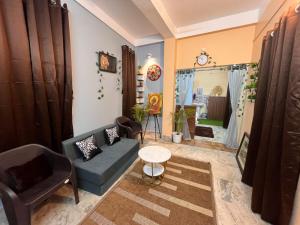 a living room with a couch and a table at Jonaki Aalay-Cozy and Budget Stay-Ulubari in Guwahati