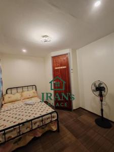 a bedroom with a bed and a red door at JRAN's Place Home in Baliuag, Bulacan in Suliban