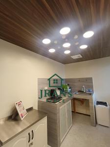 a room with a kitchen with a counter and a ceiling at JRAN's Place Home in Baliuag, Bulacan in Suliban