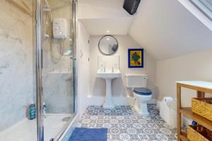a bathroom with a shower and a sink and a toilet at The Winners Enclosure - Country Flat Above a Village Pub in Shrewsbury +14 photos